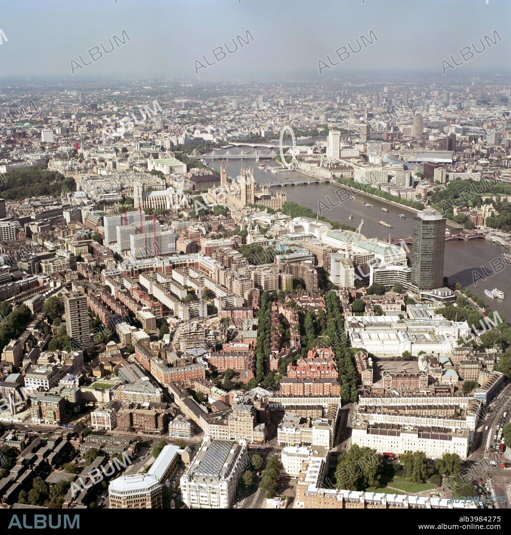 Aerial view of Westminster, London, 2002.This view shows how closely many of London's landmarks are clustered. In the middle distance are the Houses of Parliament, Westminster Abbey and the London Eye. Lambeth Palace is across the river to the right. The dome of St Paul's Cathedral can be picked out in the distance. Offices and residential buildings are packed together in the foreground.