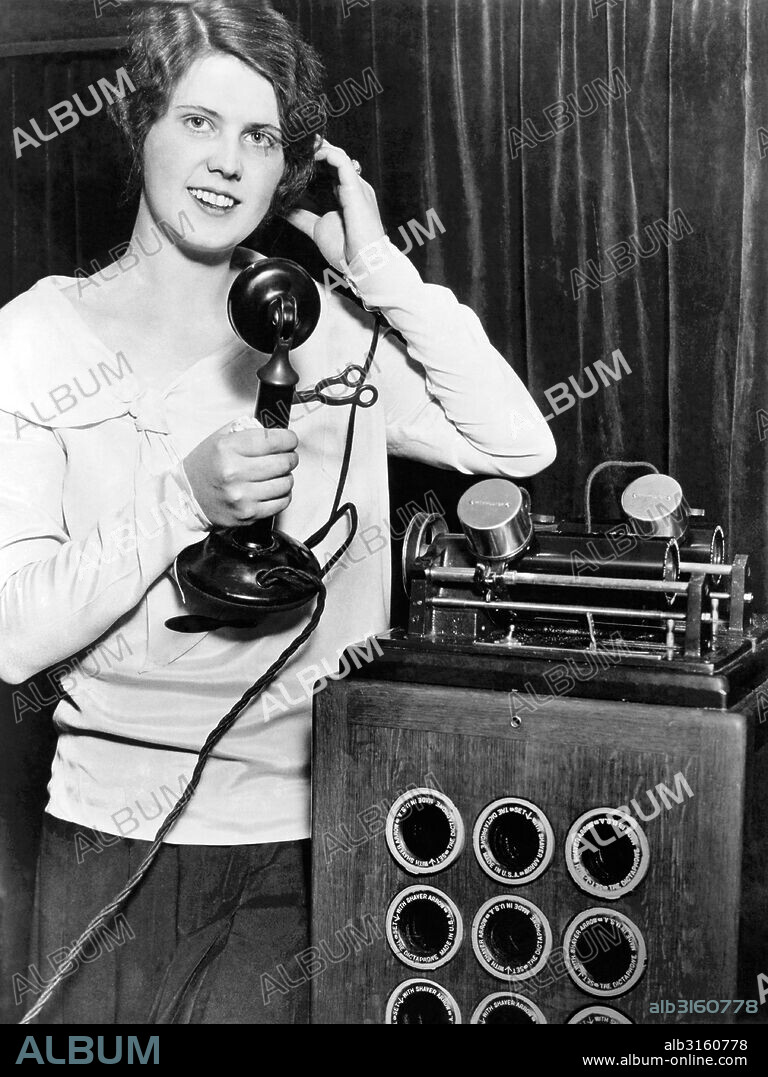 Chicago, Illinois: November 13, 1930 A young woman demonstrates the 'Teleword' machine at the National Business Show. It records both ends of a telephone conversation on wax cylinders for posterity, contracts and lawsuits.