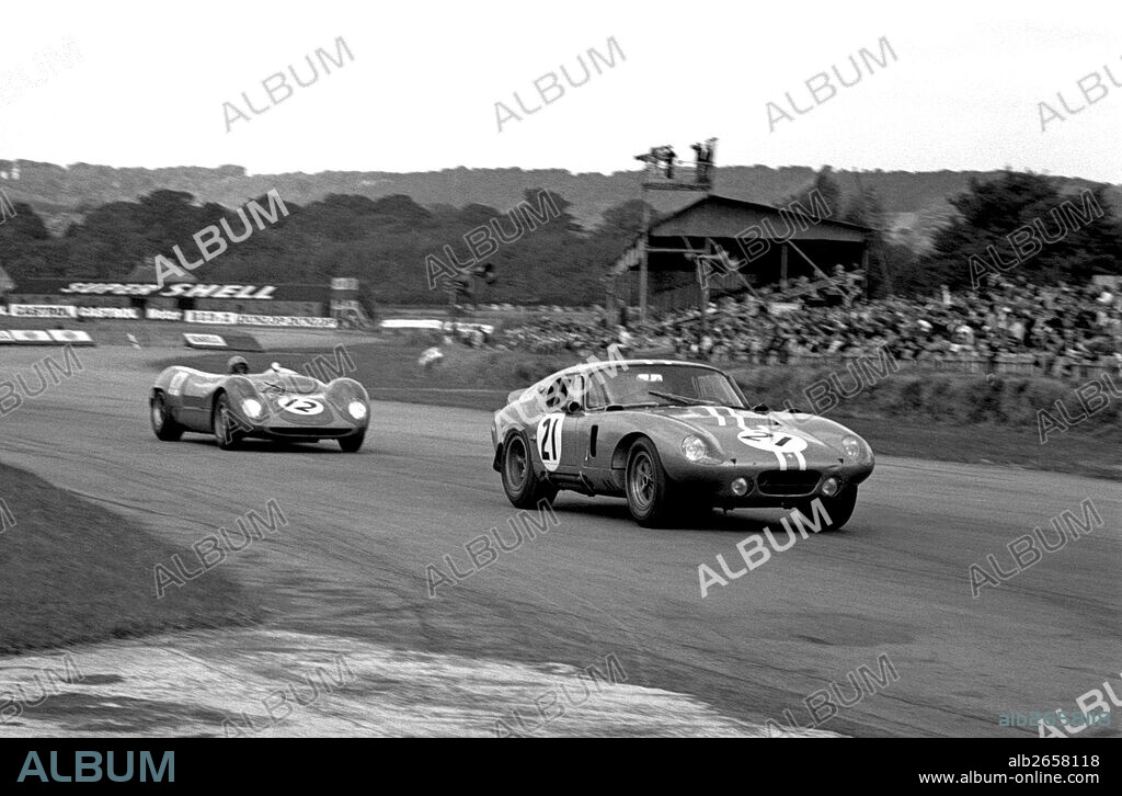 No21 Dan Gurney in a Shelby Cobra Daytona Coupe. No 12 Roger Nathan in a Brabham BT8 Climax. Goodwood TT, England 29 August 1964.