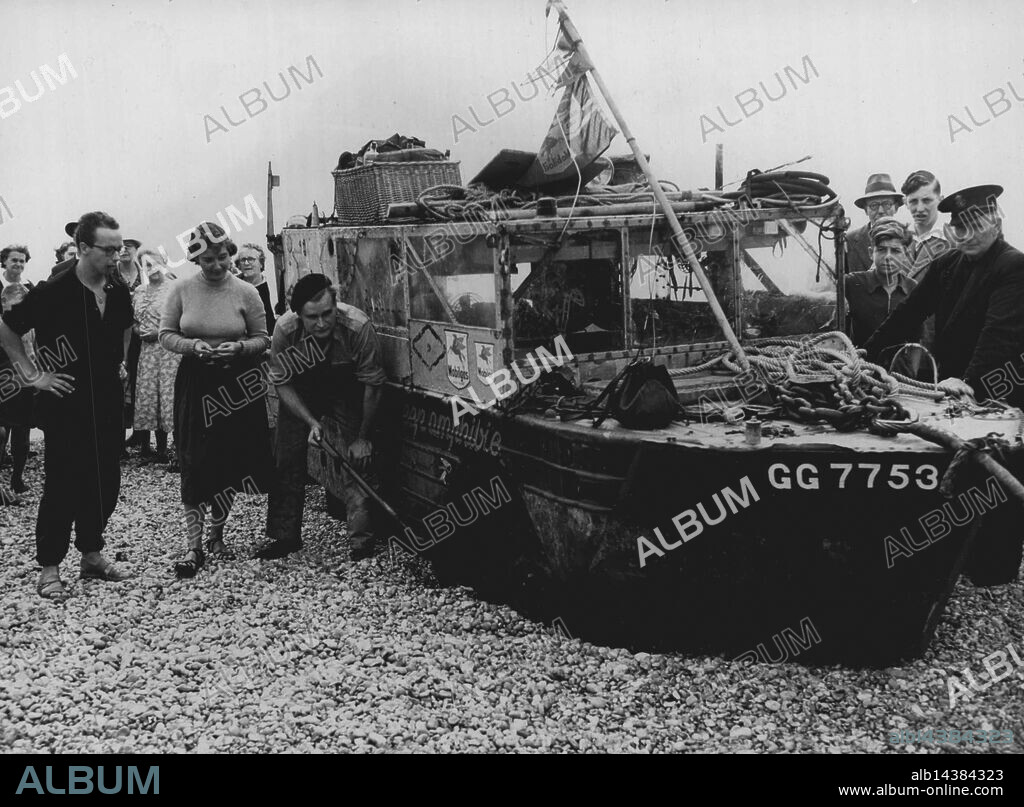 "Half -Safe" is safe...Photo Shows. "Ben Carlin digs out one of the Embeded wheels. Next to him is his wife Elinore and Mr. Theo Defrene, A Belgium who Travelled across the channel with them...The amphibious jeep "Half-Safe" which was brought ashore from the Goodwins, In the English channel today was pulled up the beach onto the roadway at Walmer, Kent, by lifeboat winch. After minor adjustments the jeep will motor to Dover for its owners, Mr and Mrs Fredrick Carlin, to obtain customs clearance, etc. They will then drive to London. Australian born Mr. Carlin and his American wife, Elinore. Are Honeymooning in the jeep, which was crossing the channel from France when it was seen to be near the centre of the Goodwins. August 25, 1951. (Photo by Paul Popper Ltd).