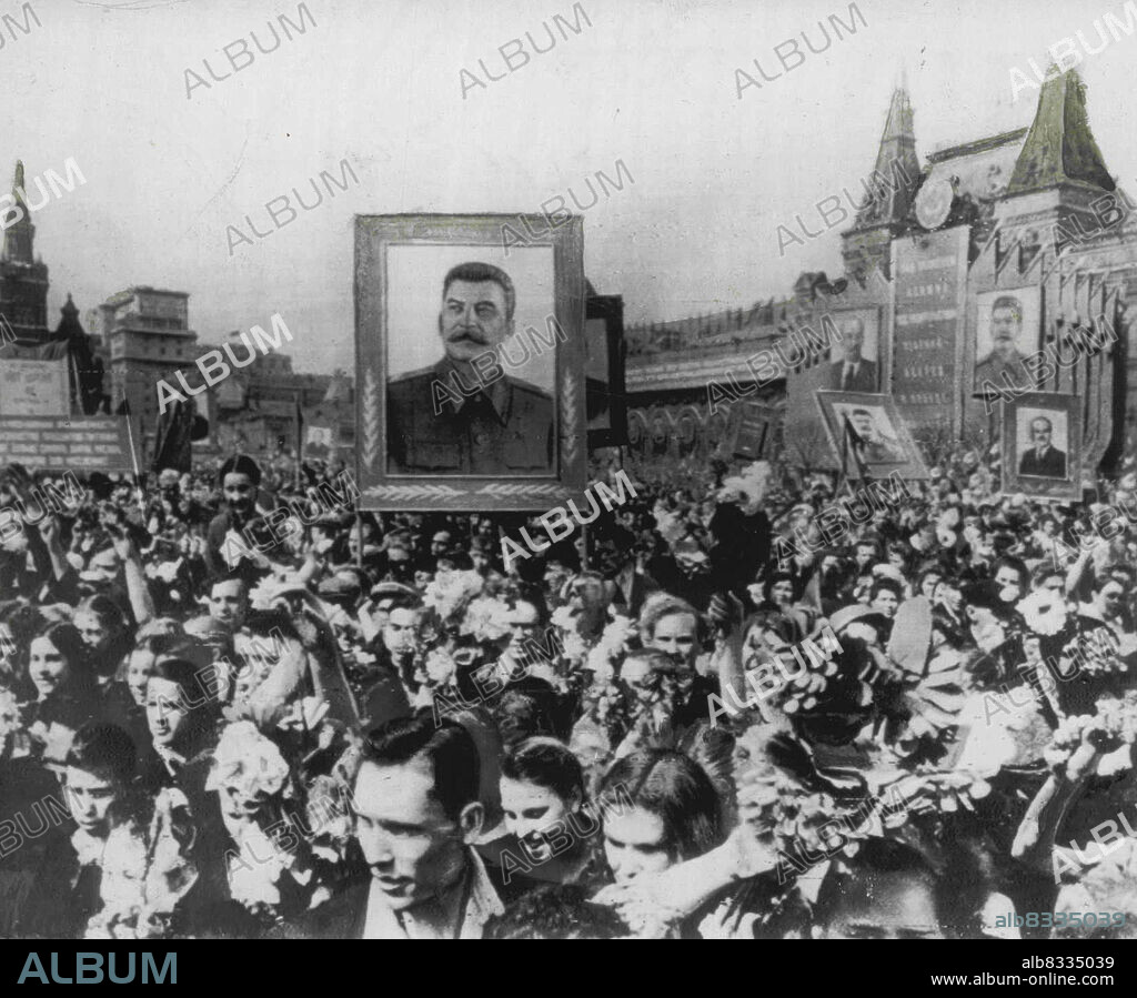 Moscow Crowds Hall May Day - A holiday mood prevails as Muscovites crowd Red Square Thursday to celebrate May Day. A huge portrait of Premier Stalin dominates the scene, along with giant-sized posters of other Red heroes. Premier Stalin reviewed the traditional May Day parade of Soviet armed might to climax the annual ceremony. This radiophoto was received in New York today by Sov photo agency. May 03, 1952. (Photo by AP Wirephoto).