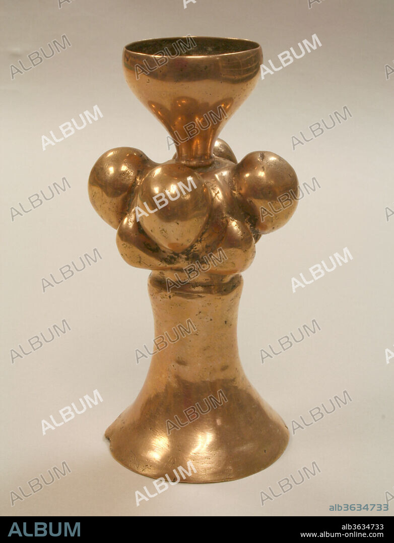 Neck of Poporo (Lime Container). Culture: Early Quimbaya. Dimensions: H. 5 3/8 x Diam. 2 5/8  in. (13.7 x 6.7 cm). Date: 300 B.C.-A.D. 700.
This metal object is the neck (<i>cuello</i> in Spanish) of a larger container, a <i>poporo</i> (or <i>juror</i> in the Guajiro languge, <i>Kuetand-tuky</i> in Páez, and <i>yoburo</i> in Arhuaco).[1] For many centuries, people in the Andes have used poporos for holding lime powder, and this is an early example of one component of these objects. This neck likely would have been attached to poporo made of a gourd. To join the two parts, a person could have used pitch, a viscous and elastic substance that can be derived from different organic materials (Plazas 2016, 266). Other examples of necks may have been attached by threading cord through perforations in the metal and joining this cord to the poporo body in some way. 

The neck consists of three registers and is symmetric on its vertical axis and partially symmetric on its horizontal. The bottom register, however, is taller and its greatest width is noticeably greater than that of the top register. In this first, top register, the neck is funnel-like, with a wider circumference at the very top that gradually narrows downward. The entire object is hollow, and the funnel is open at the bottom, so that it connects with the rest of the object's interior. Second, there is a register with eight rounded shapes. The eight shapes are spaced evenly around the circumference: there are four centered on an upper row, and four centered on a lower row, with some overlap between the two rows. The shapes in the top row are larger and more rounded than those on the bottom row. Third, the bottom register gradually curves outward toward the base of the object. A wide band of low relief separates the middle and bottom registers; the object is wider above and below this band. 

Metalworkers made this object through very precise lost-wax casting. (For more details on this process, please see Metropolitan Museum of Art 1974.271.48, a Quimbaya anthropomorphic bead.) The metal they cast for this object, which displays a golden and pink or red hue, appears to be an alloy of gold and copper. Silver also may be present, as an inherent component of the gold source, as noted in the analysis of other Quimbaya metal objects (see Uribe 2005, 83). These objects, including the present example, were produced in a region that includes parts of the Central Cordillera of Colombia and extends through much of the Cauca River Valley, from the department of Antioquia to the northern part of the Valle de Cauca department.[2] Its production is part of the Early Quimbaya tradition of metalworking, dating between approximately 300 B.C. and A.D. 700. 

The metal of the top and bottom registers is especially thin. There is fine, localized porosity in different regions of the object, resulting from the trapping of gas molecules in the molten metal as it cooled. In these areas, the thin gold surface, likely produced through enrichment, has worn away to reveal corroded metal underneath. Overall, and especially outside of these recesses, the metal is highly polished. 

The hollowness of the present object is vital to its association with the body of the poporo. A person would insert a <i>palillo</i>, or lime dipper, into the top of this neck, where there is a narrow perforation leading into the main part of the neck. The palillo would need to extend the entire length of the neck and then into the attached poporo in order to scoop up the lime. People use this lime in the consumption of coca (<i>Erythroxylum novogranatense</i>). Mixing the lime with the coca leaves that people chew helps to activate some of the beneficial properties of the coca plant, which can serve as a stimulant and help reduce fatigue or hunger. Today, wooden stoppers may be inserted into the top of the poporo. Among Native communities in the Sierra Nevada de Santa Marta, in northern Colombia, men receive poporos when they reach adulthood, but in other parts of the Andes, women also use poporos. (For more information on the use of poporos, please see 1979.206.776.) 

Each of the eight shapes in the object's middle register may actually be a manifestation of a gourd, a major component of Quimbaya iconography. These gourds tend to be in the form of <i>calabazos (Lagenaria siceraria)</i>, <i>calabazas</i> (<i>Cucurbita pepo</i> among other species), and <i>totumas (Crescentia cujete)</i>. Poporos made of gourds are used by people today and may have been common in the past, but conditions of preservation have favored the metal poporos. People use much larger gourds as storage containers for food or water. Uribe (2005, 76) proposes that metalworkers may have taken some of these gourd poporos or the gourds themselves as inspiration for the metal versions. Several examples of poporo necks were part of an assemblage of 16 objects found in 1987 at the site of Puerto Nare in the middle Magdalena River Valley in Antioquia. One of these necks features rounded shapes similar to those on the top row of shapes on the present example, but they appear at the top rather than the middle of the neck (see Museo del Oro 2008, 94). Another example similar to the one from Puerto Nare was found at Pajarito in Antioquia (Pérez de Barradas 1965, pl. 1). In this case, however, the body of the poporo is metal, and it is possible that the neck and body were cast together as one piece. Another neck shows a row of human heads that wrap around the object's circumference (British Museum 1940.10.17.2). 

The assemblage from Puerto Nare was identified around a century after the "Tesoro de los Quimbayas" was excavated from two burials in La Soledad in the Quindío department. This "Tesoro" was one major aspect of how the "Quimbaya" region came to be defined in the late 19th and early 20th centuries. Quimbayas were a group of people known to live in the 16th century on the eastern side of the Cauca River, south of Manizales and north of the La Vieja River (Herrera 1992, fig. 167; Langebaek 2016, 281; Uribe 2003, 26). They were among several Native groups living in the wider region of the Cauca Valley, including Quindos, Carrapas, Irras, Quinchías, and Picaras, their names being assigned by Spanish colonists. Early <i>huaquería</i> often involved people moving into this region from the northern parts of Antioquia, fleeing local conflicts and interested in the extraction of <i>caucho</i> (a form of rubber acquired from trees) for global export (Gamboa 2002, 61-62). The interest in Indigenous pasts became deeply related to the construction of the Colombian state (Villegas 2009).[3] Antiquarians like Ernesto Restrepo reconciled the objects excavated from this region, including the "Tesoro," with Spanish colonial texts. Restrepo (1929) helped create a "Quimbaya" race, inventing statements about their origins and practices. Over time, archaeologists have shifted the academic attention towards the Indigenous pasts of this region by studying settlement patterns and recognizing the longevity of its occupation (see Santos and Otero 2003).[4] The first human presence in the middle Cauca region has been shown to be ca. 10,000 years ago (Jaramillo 2008, 6), and there is support for referring to the archaeological region as "Middle Cauca" ("Cauca Medio") instead of "Quimbaya" (Cano 1995, 37). 
Bryan Cockrell, Curatorial Fellow, Arts of Africa, Oceania, and the Americas 
2017
Related objects: 1974.271.48, 1979.206.529, 1979.206.776, 1991.419.22, 1995.481.6 
[1] Wiedemann (1979, 304) notes these terms. 
[2] See Sáenz-Samper and Martinón-Torres 2017 for a discussion of another example of this red-gold surface color on metal objects in the northern Andes.
[3] Adrián Villegas kindly offered further insights on this historical context. 
[4] Pablo Muñoz generously suggested this article.