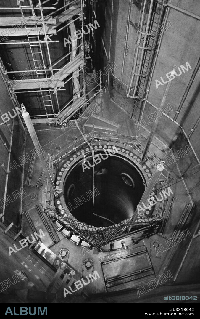 Reactor vessel of the Virgil C. Summer Nuclear Generating Station, near Jenkinsville, South Carolina; photographed prior to the facility's opening in mid-1981.  The vessel extends down 50 feet into the ground and 157 nuclear fuel assemblies will sit down in the reactor.  One-third of the fuel will be removed each year and new fuel added to replace it.  A reactor vessel head will sit atop the vessel, which appears here as a dark hole.  The surrounding space is the containment area.