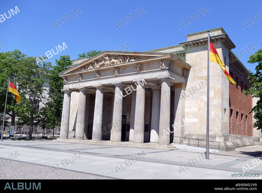 The Neue Wache (New Guardhouse) in Berlin, Germany. It serves as the "Central Memorial of the Federal Republic of Germany for the Victims of War and Dictatorship". It is located on the north side of the Unter den Linden boulevard in the central Mitte district. Dating from 1816, the Neue Wache was designed by the architects Karl Friedrich Schinkel and Salomo Sachs. It is a leading example of German Greek Revival architecture.