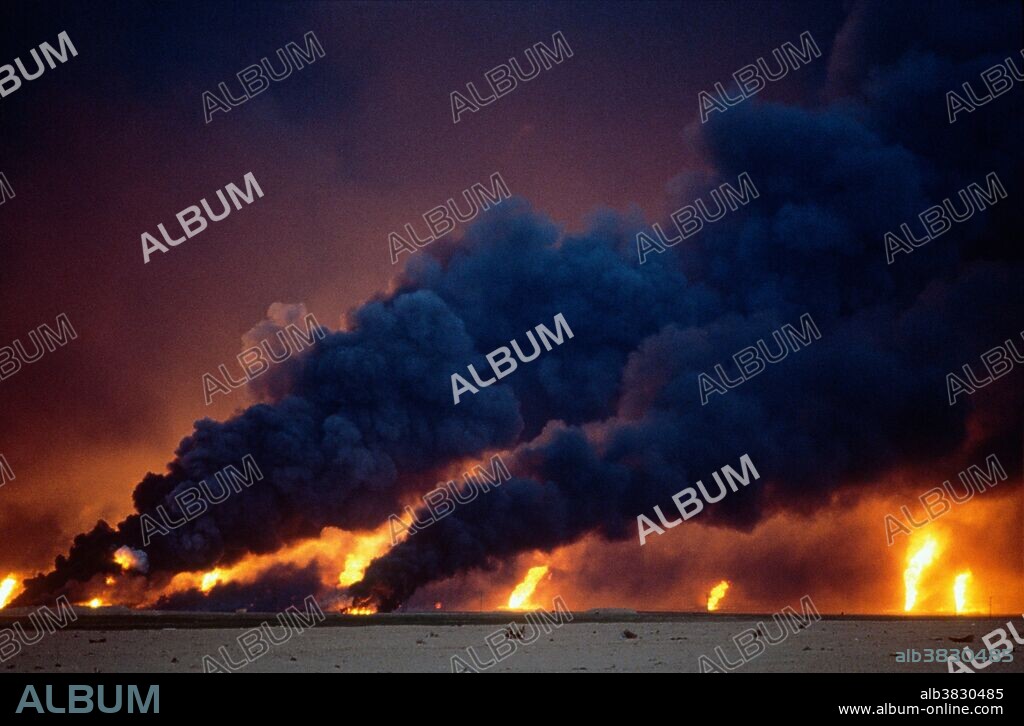 Oil wells burning out of control in the Al-Ahmadi oil fields located on the outskirts of Kuwait City. The oil fields were set on fire by retreating Iraqi troops hoping to create some cover from American airplanes strafing their positions. The fires and smoke caused one of the greatest environmental disasters of modern times. Nearly 800 oil wells were set ablaze by the retreating Iraqi army and the fires were not fully extinguished until November 6, 1991, eight months after the end of the war. The fires consumed an estimated six million barrels of oil daily. Their immediate consequence was a dramatic decrease in air quality, causing respiratory problems for many Kuwaitis. The sabotage of the oil wells also impacted the desert environment, which has a limited natural cleansing ability. Un-ignited oil from the wells formed about 300 oil lakes that contaminated around 40 million tons of sand and earth.