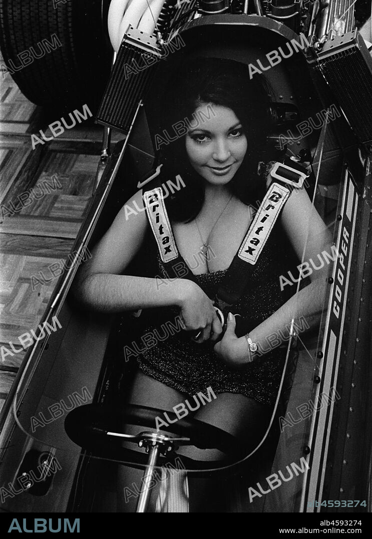 Female model in cockpit of Cooper F5000 at 1969 Racing Car show.