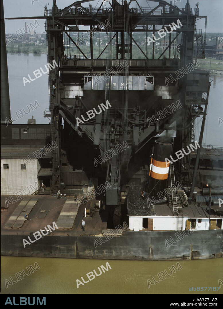 JACK DELANO. Loading coal into a lake freighter at the Pennsylvania Railroad docks, Sandusky, Ohio.