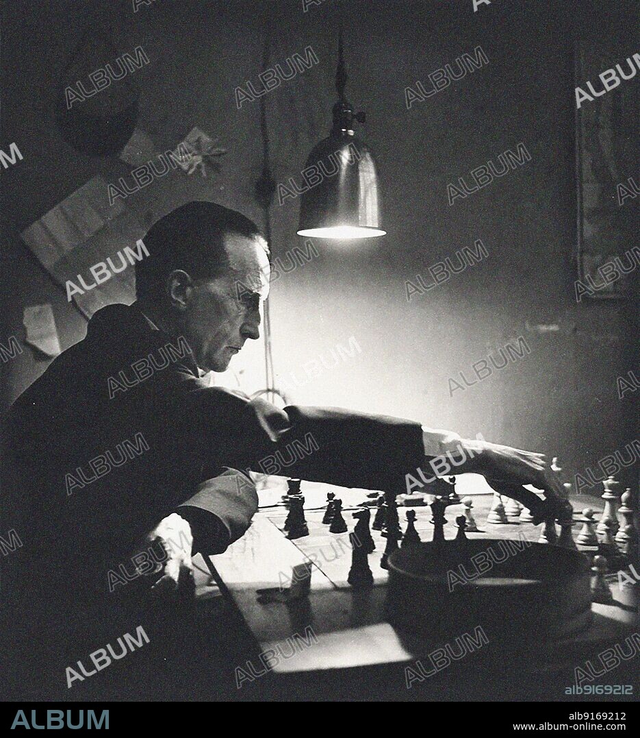 KAY BELL REYNAL. Marcel Duchamp playing chess in his studio.