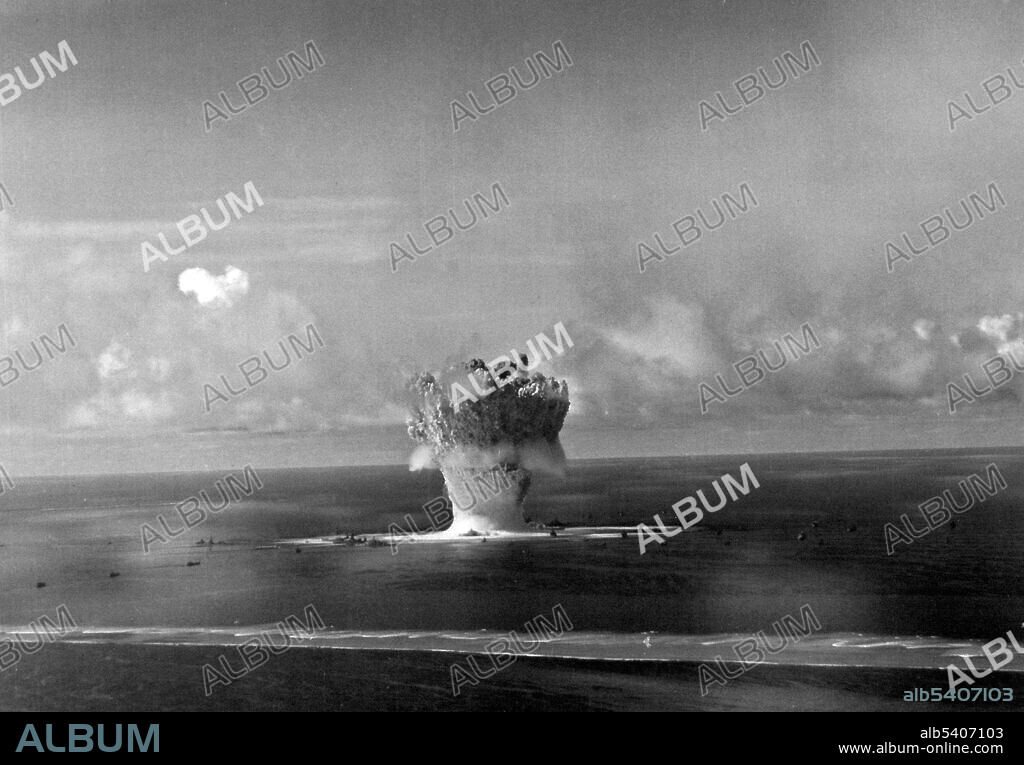 Operation Crossroads BAKER Underwater A-Bomb Test, July 25, 1946. Frame 10 of a series of aerial views, taken from PBM W about one second after detonation. Identifiable ships are, (left to right): USS Salt Lake City; USS New York; Japanese battleship Nagato; USS Nevada; USS Arkansas; USS Saratoga; USS Pennsylvania; and USS Pensacola.