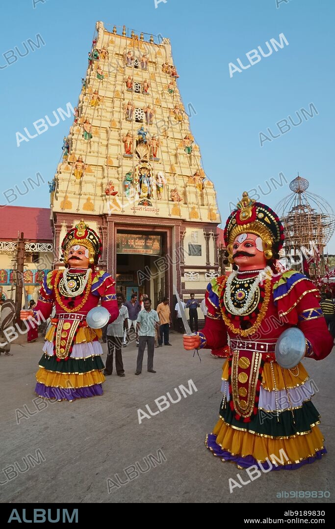 India: Giant warrior figures, with a man hidden inside each, take part in a procession during a festival around Balkrishna Temple or Udupi Sri Krishna Matha in Udupi (Udipi), Karnataka, South India. The men usually advance their figures with quick, swirling movements, occasionally halting to re-adjust their setup. They look out from their figures through a round opening in the figureÄôs lower chest area. The temple is dedicated to the young and playful version of (Hindu god) Krishna called Balkrishna (Boy Krishna).