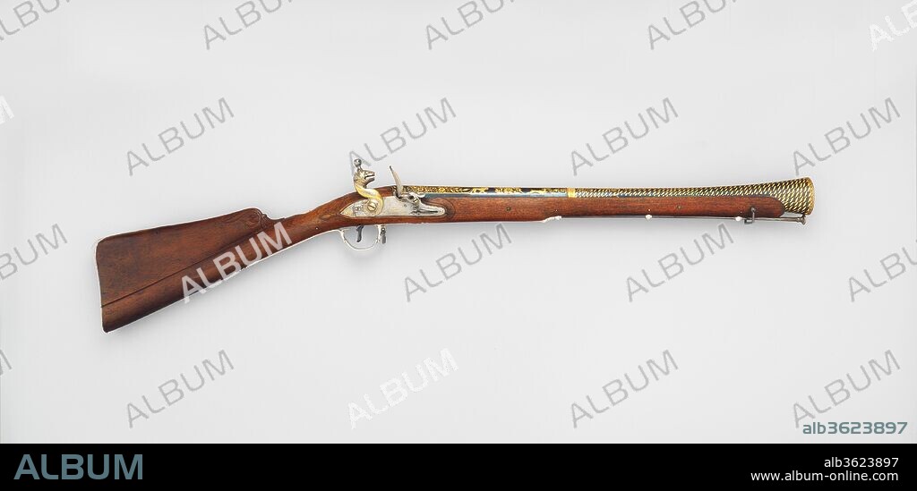 Flintlock Blunderbuss. Culture: Indian, Seringapatam. Dimensions: L. 37 1/2 in. (95.3 cm); L. of barrel 21 1/8 in. (53.8 cm); Cal. 1.75 (53.8 cm) Wt. 6 lb. 4 oz. (2831 g). Date: dated Mauludi era 1222/A.D. 1793-94.
This gun was made in Seringapatam, the capital of Tipu Sultan (1750-1799), the ruler of Mysore. Tipu's armories employed many European craftsmen, and his firearms reflect the most up to date technology. As the self-styled "tiger of Mysore," Tipu was preoccupied with tiger imagery. On this gun, tigers prance or hunt on the magnificently damascened barrel; the cock of the flintlock is fashioned as a tiger head; and the silver mount is stamped with stylized tiger-stripe marks. Following the storming of Seringapatam by the British on May 4, 1799, during which Tipu was killed, this gun and many other weapons were taken to Europe as booty.