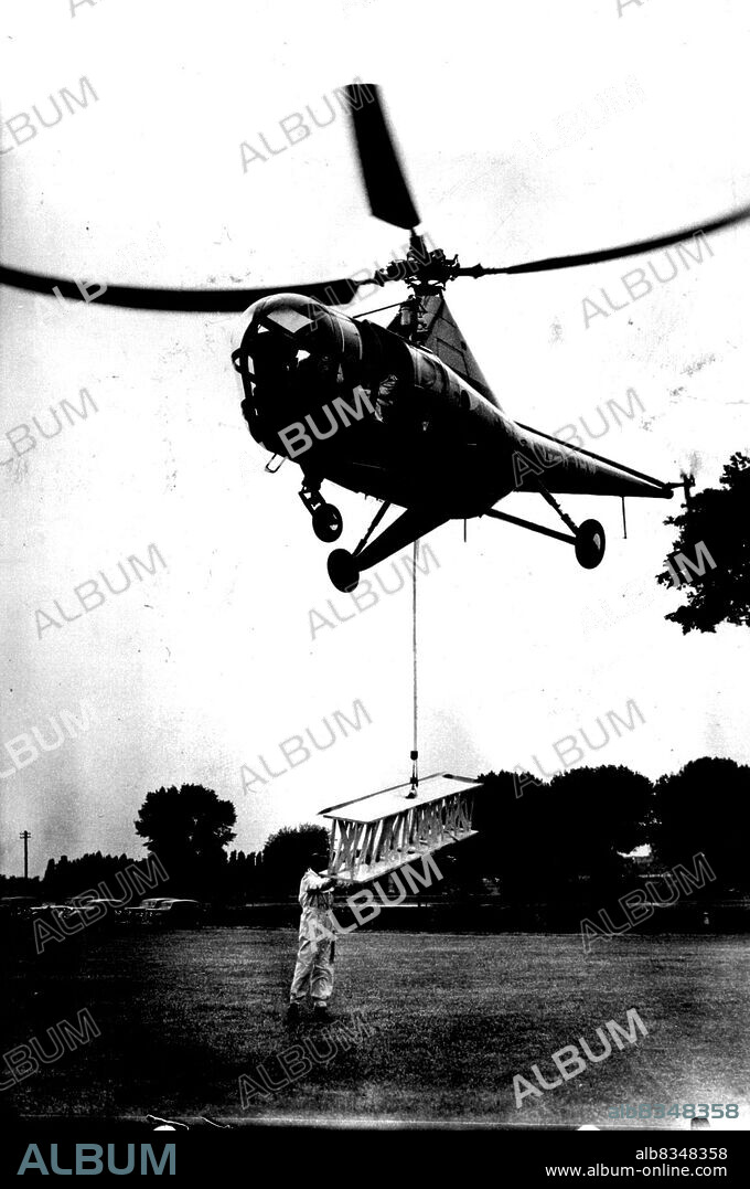 Aerial Crane. The "Westland Sikorsky," the first commercial-type helicopter available in Europe demonstrates how it can drop its own hoisting gear and while hovering, pick up a steel girder, offering an easy method of bridging a river from the air. The aircraft accommodates a pilot and three passengers in a luxury cabin, air-conditioned and warmed. June 1, 1947. (Photo by Sport & General Press Agency, Limited).