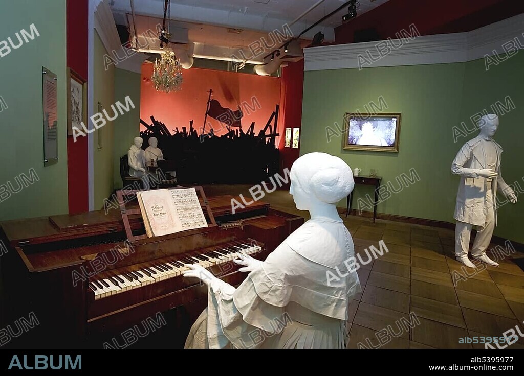 Femal mannequin dressed in biedermeier style sitting at the piano in a historic living room, background showing a revolution scene, exhibition the story of berlin, Charlottenburg, Berlin, Germany