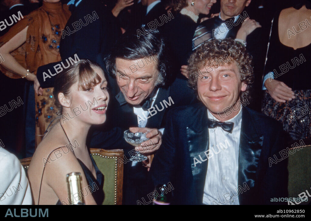 German actress Olivia Pascal with partner Achim Lenz (right) and actor Herbert Fux (center) visiting the Filmball, Germany 1980s.