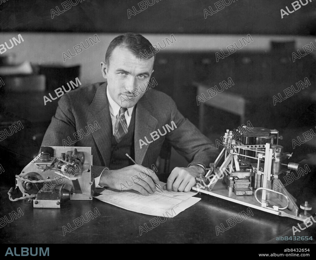 Orig. bildtext... TO MEASURE VELOCITY OF EARTHQUAKE WAVES. Cambridge, Mass. - Dr. L. Don Leet, Harvard University, who is directing research work of the Geology Department of the University which will this summer try to determine the substance and measurement of the earth by a series of dynamite explosions. By these man-made earthquakes, it is hoped to measure the velocities of earthquake waves through granite in an attempt to prove that the shell of all continents are granite base. Dr. Leet is one of the world's best known seismologists and is shown here with the three component portable seismograph built specially for this research work. Anm. Seismografer Mätinstrument persons: L. DON LEET sites: BOSTON ;USA.