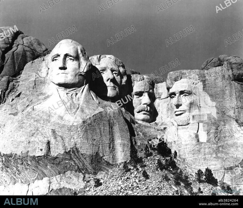 Mount Rushmore National Memorial is a sculpture carved into the granite face of Mount Rushmore near Keystone, South Dakota. Sculpted by Danish-American Gutzon Borglum and his son, Lincoln Borglum, Mount Rushmore features 60 foot sculptures of the heads of four United States presidents: George Washington, Thomas Jefferson, Theodore Roosevelt, and Abraham Lincoln. Construction on the memorial began in 1927, and the presidents' faces were completed between 1934 and 1939. Although the initial concept called for each president to be depicted from head to waist, lack of funding forced construction to end in late October 1941. Mount Rushmore has become an iconic symbol of the United States, and attracts over three million visitors annually. NPS, no photographer credited, 1941.