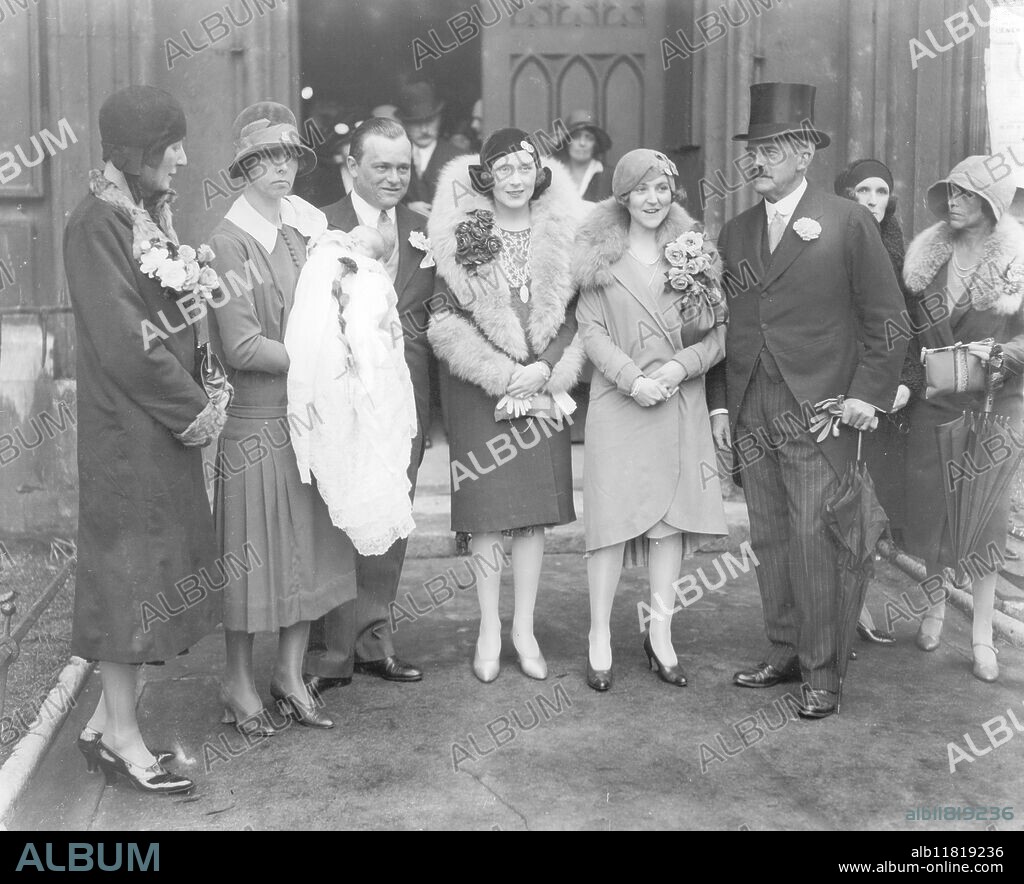 Miss Barbara Cartland (Mrs. Hugh McCorquodale) the famous authoress at the christening of her daughter at St. Margaret's, Westminster. L-R:- ? Nurse and baby, Mr. and Mrs. Hugh McCorquodale, Mrs. C. A. Kershaw and General Sir Francis Davis (godfather). 8th October 1929.