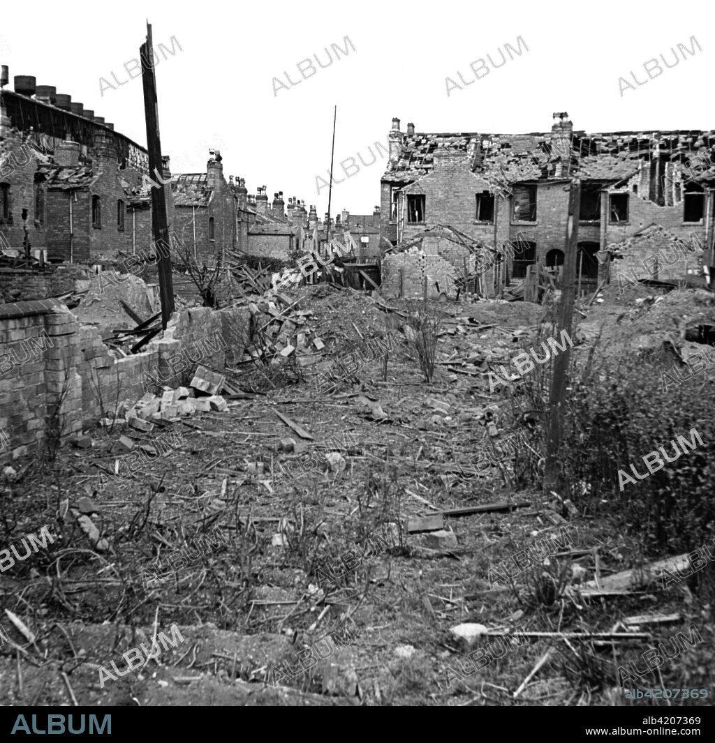 Wartime bomb damage, Long Acre, Nechells, Birmingham, West Midlands, World War II, 29 July 1942. View of the rear of Long Acre and Crompton Road showing bomb damage which included a direct hit on a shelter.