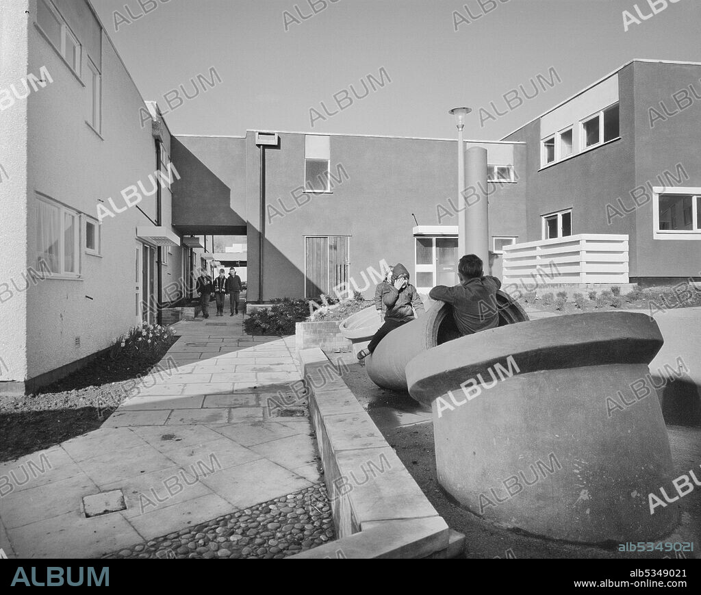 JOHN LAING PLC. Children playing on sculptures in a children's play area on the Greenmeadow housing estate in Cwmbran. The negative register records this image as being Cwmbran Site 2 off of Ty-Gwyn Road, which was a project for the Cwmbran Development Corporation. Cwmbran was designated as a new town in 1949 under the New Towns Act of 1946. The town was intended to provide new employment opportunities in the south eastern section of the South Wales Coalfield.