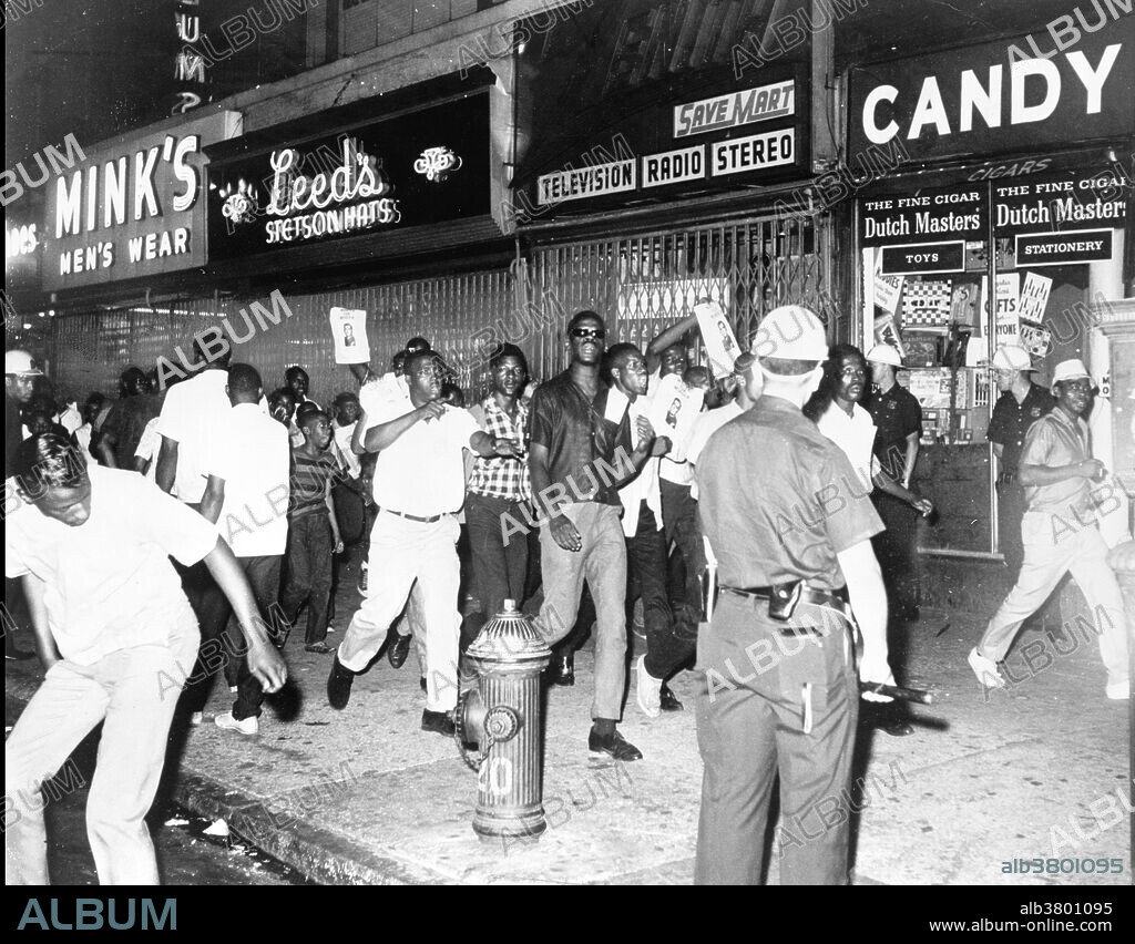 Entitled: "The fatal shooting of Powell stirred Negro rioters to race through Harlem streets carrying pictures of Lt. Gilligan." On Thursday, July 16, 1964, James Powell was shot and killed by police Lieutenant Thomas Gilligan. The second bullet of three fired by Lieutenant Gilligan killed the 15-year-old African American in front of his friends and about a dozen other witnesses. The incident immediately rallied about 300 students from a nearby school who were informed by the principal. This incident set off six consecutive nights of rioting that affected the New York City neighborhoods of Harlem and Bedford-Stuyvesant. In total, 4,000 New Yorkers participated in the riots which led to attacks on the New York City Police Department, vandalism, and looting in stores. At the end of the conflict, reports counted one dead rioter, 118 injured, and 465 arrested. Photographed for the New York World-Telegram & Sun by Dick De Marsico, 1964.