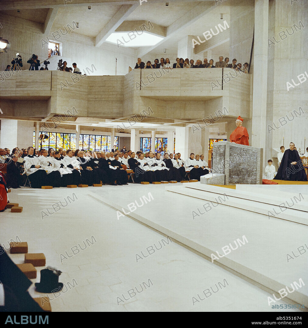 JOHN LAING PLC. Cardinal John Heenan, Archbishop of Westminster, addressing the congregation in Clifton Cathedral during the consecration ceremony. This Roman Catholic Cathedral was designed by Ronald Weeks, E S Jennett and Antoni Poremba of the Percy Thomas Partnership. It was built by John Laing & Son Limited between 1969-1973 and was constructed using pre-cast concrete panels and in-situ concrete. In 1974 it received the Concrete Award from the Concrete Society.