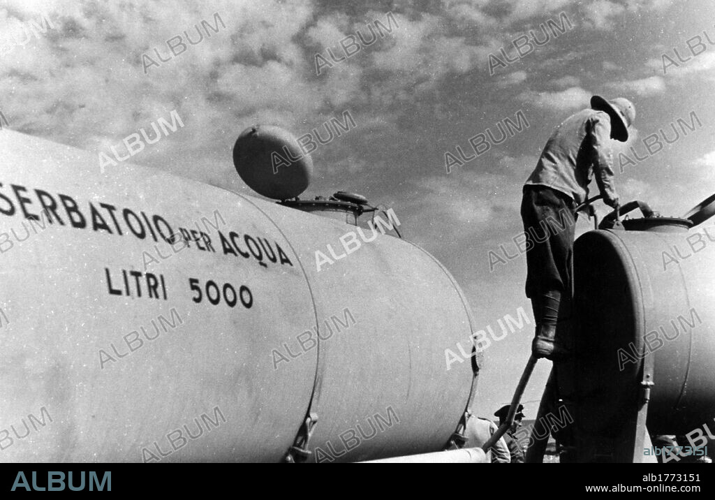 Water supply in an Italian base in Sirtica. Replenishing two water tanks in an Italian Army base in Sirtica. Libya, April 1941.