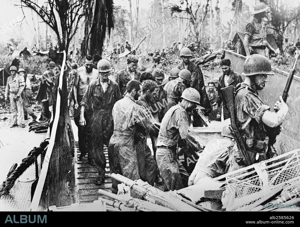 GUADALCANAL.US Supplies unloaded on Guadalcanal.US forces unload supplies from a landing barge at Kokumbuna on Guad. in the Solomons in a downpour.Despite heavy seasonal rains,USforces completed their conquest of the island by annihilating.