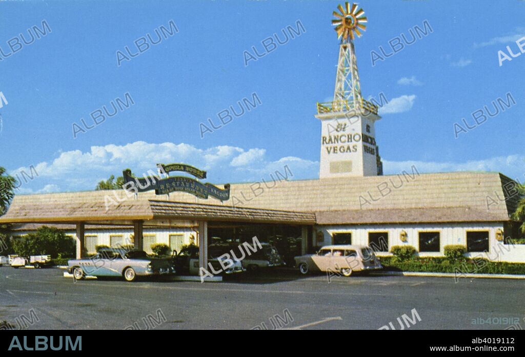 El Rancho Vegas Hotel, Las Vegas, Nevada, USA, 1956. Vintage postcard showing the entrance to the El Rancho Vegas with its signature windmill atop a tower. Parked cars are in the drive and under the porte cochere. El Rancho Vegas was the first hotel and casino to be built on what wouls become the Las Vegas Strip. It opened in 1941 but was destroyed by fire in 1960.