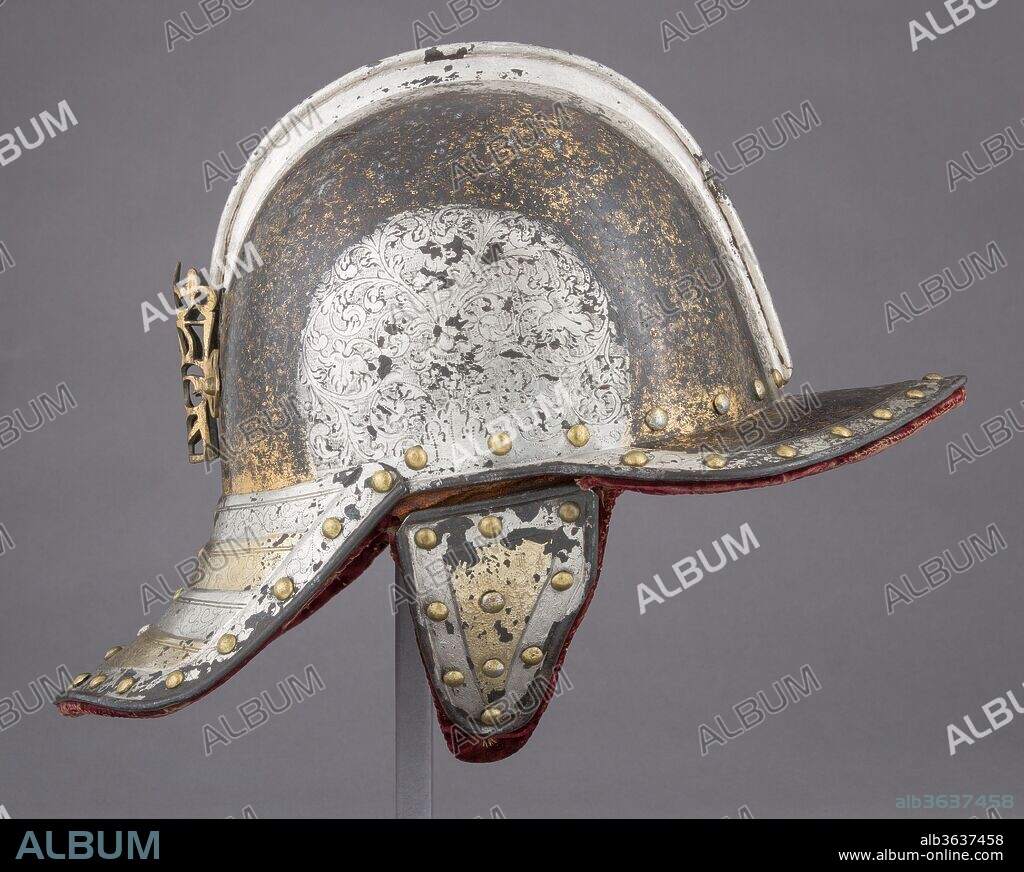 Lobster-Tail Burgonet for a Harquebusier. Culture: Dutch or British. Dimensions: H. 11 in. (27.9 cm); W. 8 in. (20.3 cm); D. 13 in. (33 cm); Wt. 2 lb. 9 oz. (1154 g). Date: ca. 1610-20.
The rich decoration of this helmet is exceptional, covering it completely with wide bands of chiseled and punched floral designs alternating in silver and gold. Although it was once believed that its neck plate, cheekpieces, plume holder and lining were later restorations, futher study has confirmed that they are genuine and original to the helmet.  In its quality and elaborate ornament, this helmet is similar to a Dutch armor in the Tower of London, which was made in 1612 for Henry, Prince of Wales.