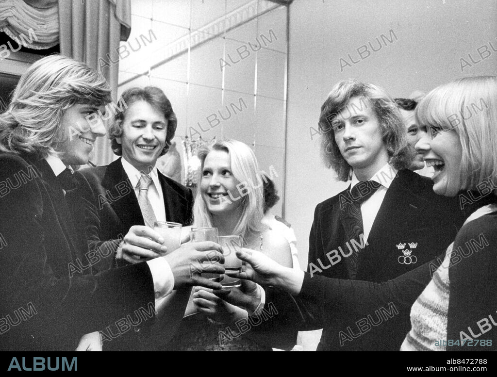 Stockholm 1975-12-21. Tennisspelarna Björn Borg (tv) och Rolf Norberg (th) plus andra, inte identifierade, personer skålar under en fest efter Davis Cup-segern över Tjeckoslovakien. . Foto: John Kjellström / SvD / TT / kod 12014.
