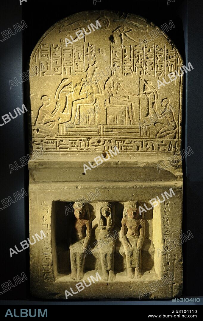 Relief divided into two scenes. At the top, Anubis and Osiris sitting with men kneeling in front of them. Hieroglyphics above and below the scene. Traces of red and blue color. At the bottom, three people sitting in relief: a woman flanked by two men. Traces of polychromy. Made for the priest of Ammon Amunked and his wife Neftretanuket by his son Userhat. Museum of Mediterranean and Near Eastern Antiquities. Stockholm. Sweden.