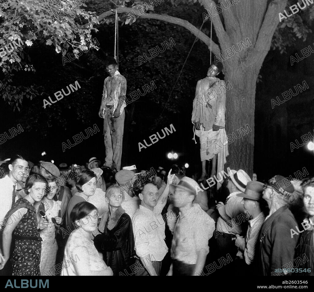 The lynching of Thomas Shipp and Abram Smith. The African-Americans were arrested as suspects, accused for robbery, murder and rape. An angry mob broke them from jail and proceeded to beat/lynch them. Marion, Indiana 1930.