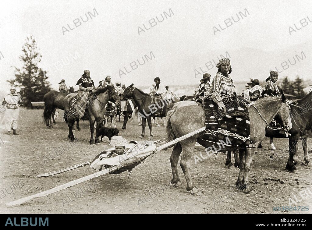Native American baby transport. A baby attached to a travois, a sled used by the Plains Indians of North America to drag loads over land. Lake Windemere, British Columbia, 1922.