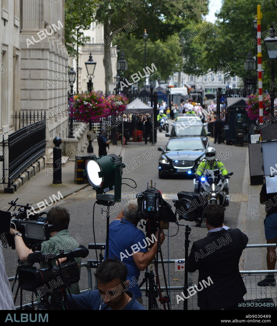 press gathered in Downing Street, London, the official residences and offices of the Prime Minister of the United Kingdom and the Chancellor of the Exchequer. Situated off Whitehall, a few minutes' walk from the Houses of Parliament, Downing Street was built in the 1680s by Sir George Downing.