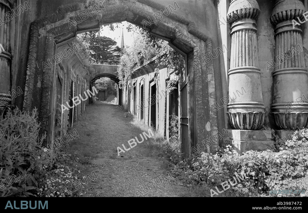 The Egyptian Avenue, Highgate Cemetery, Highgate, Hampstead, London, 1945-1980. View of a street of family vaults inspired by ancient Egyptian tombs. These catacombs are a striking feature and the path leads off the famous Circle of Lebanon, a sunken ring of tombs around a cedar tree. Highgate Cemetery, the third private cemetery on the fringe of London, was opened in 1839.
