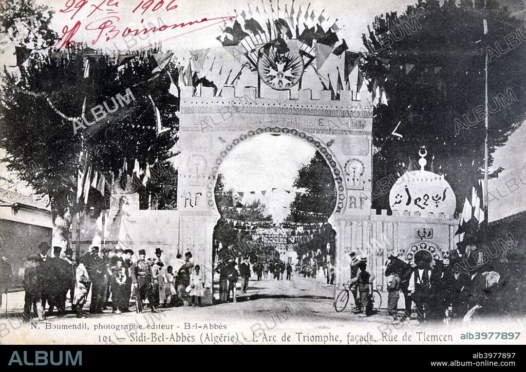 Arc de Triomphe facade, Sidi Bel Abbes, Algeria, 14 July 1906. A mock Arc de Triomphe and bunting strung across the street to commemorate Bastille Day. Sidi Bel Abbes was the headquarters of the 1st Regiment of the French Foreign Legion. French postcard.