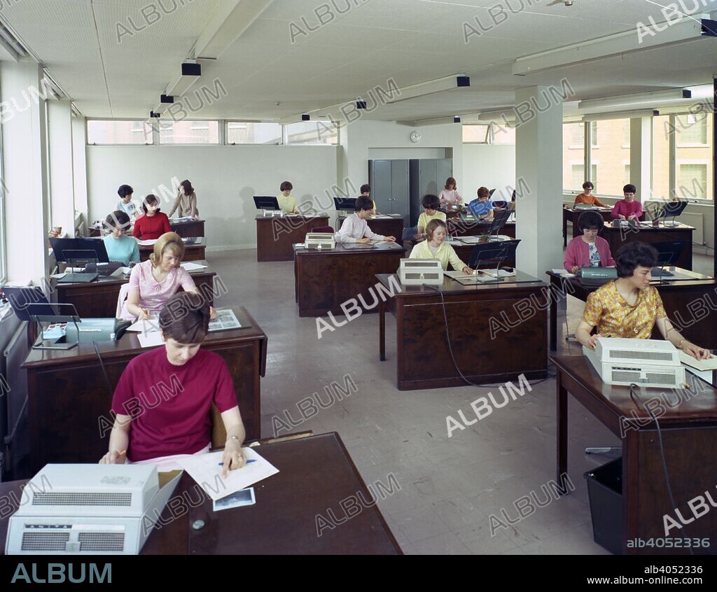 Administration office at Huntsman House, Leeds, West Yorkshire, 1968. Huntsman House was the headquarters of Tetley's brewers. Here, female workers in the accounts department use Sumlock machines, a forerunner of the calculator.