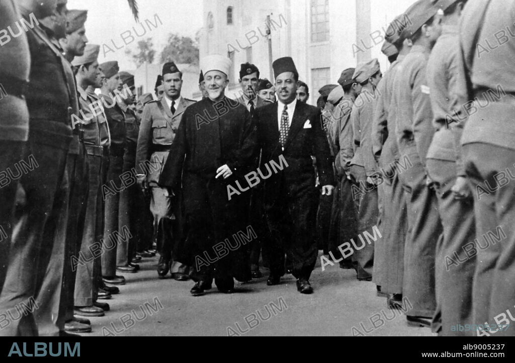Haj Amin al-Husseini, The Grand Mufti of Jerusalem and head of the Arab Higher Committee, reviewing a guard of honorat a village in Galilee on 23 April 1947.