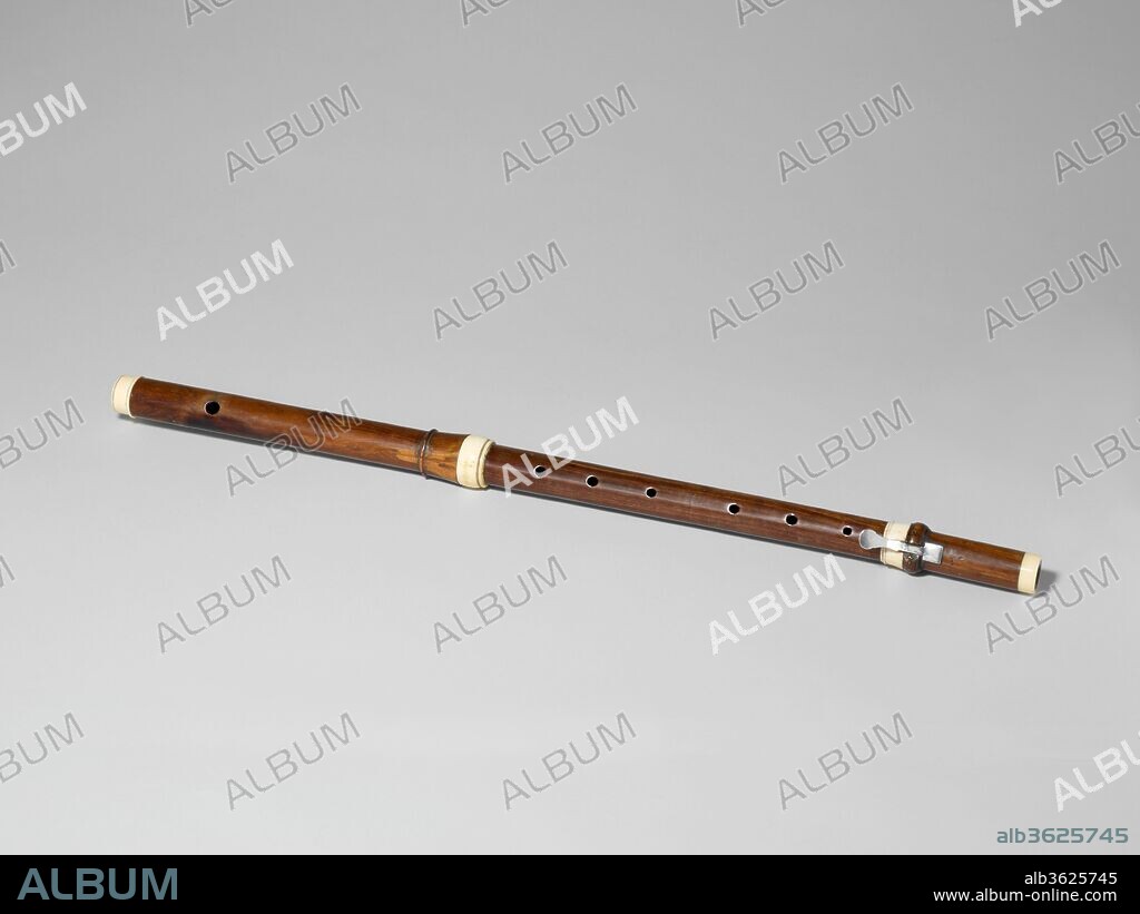 Transverse Flute. Culture: French. Dimensions: L. 65.8 cm (25 7/8 in.); external diameter from head to foot 2.9 cm (1 1/8 in.) to 2.5 cm (1 in.); diameter of mount 3.6 cm (1 7/16 in.). Manufacturer: Garion (French). Date: ca. 1720-40.
This flute is a late example of the three joint design pioneered by the Hotteterre family during the seventeenth century. Making flutes with separate joints instead of in one piece allowed instrument makers to have greater control over the tapering of the internal bore profile, which improved intonation and response. Although this flute lacks the Baroque-style decorative balusters and beads of Hotteterre-type flutes, its basic layout and tonehole placement mirrors that of Hotteterre's instruments.