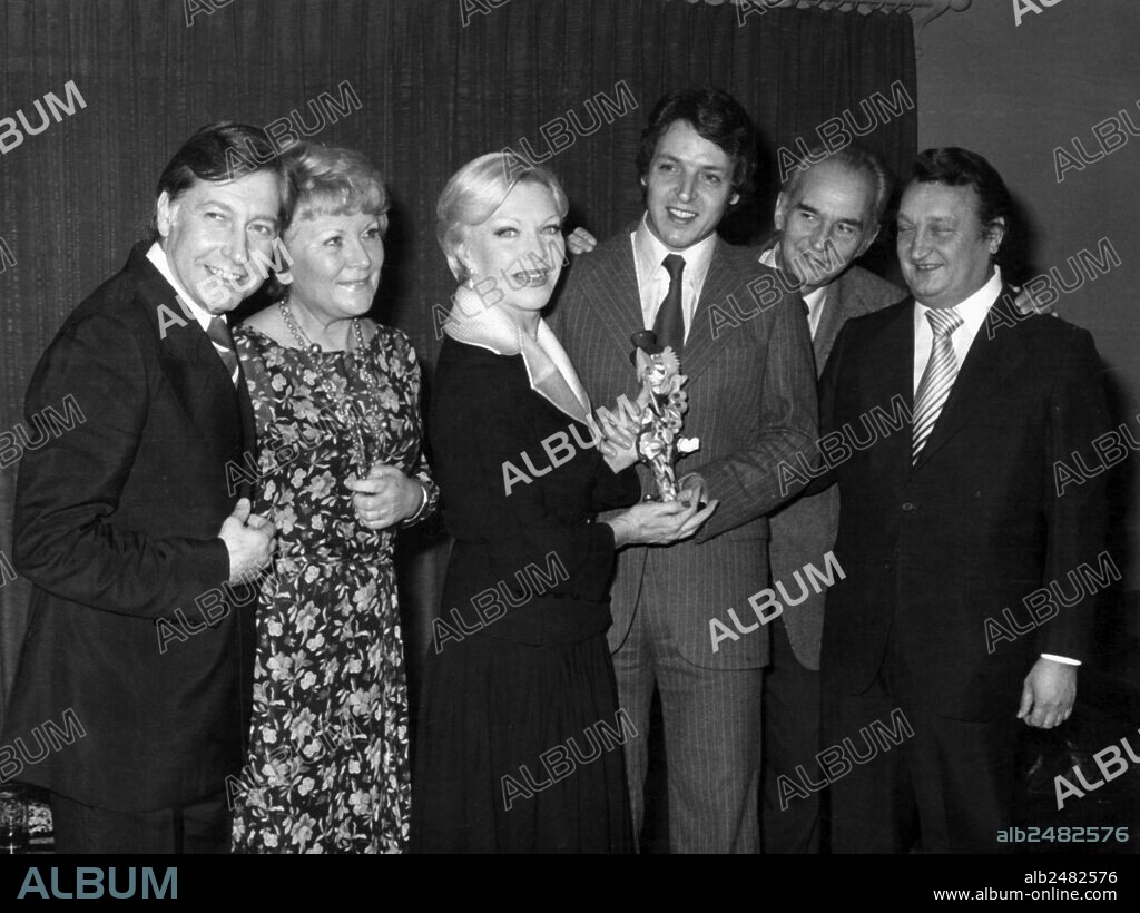 French singer Line Renaud celebrating her thirtieth birthday of career with Patrick Duhamel and the Sourire prizewinners, end of the 70's.