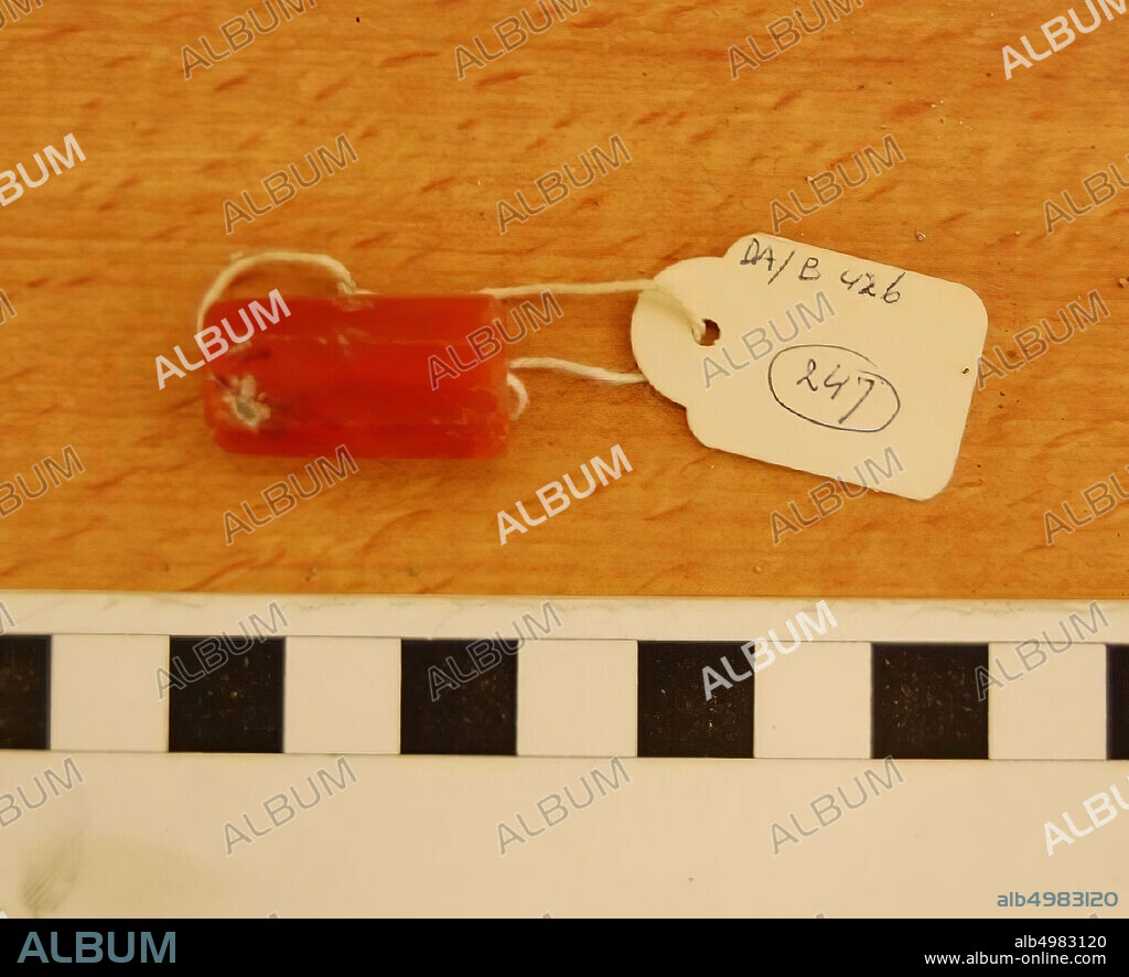 Elongated bead with eight surfaces, slightly damaged, orange color, ornament, stone, carnelian, L 2.5 cm, W 1.35 cm, H 0.8 cm, D hole 0.2 cm, Iron Age 1150-539 BC, Jordan.