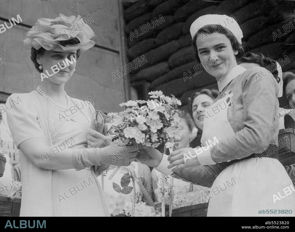 Duchess of Kent Makes Alexandra Rose Day Tour In London -- The Duchess of Kent being presented with a bouquet at the St. George's hospital depot when, in accordance with a tour of the Alexandra Rose Day depots in London today, June 25. June 25, 1940. (Photo by Associated Press Photo).
