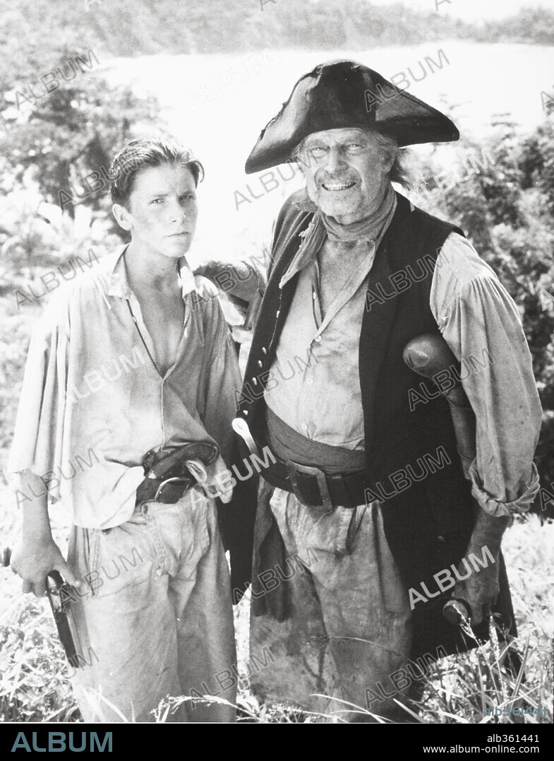 CHARLTON HESTON and CHRISTIAN BALE in TREASURE ISLAND, 1990, directed by FRASER HESTON. Copyright WARNER BROTHERS.