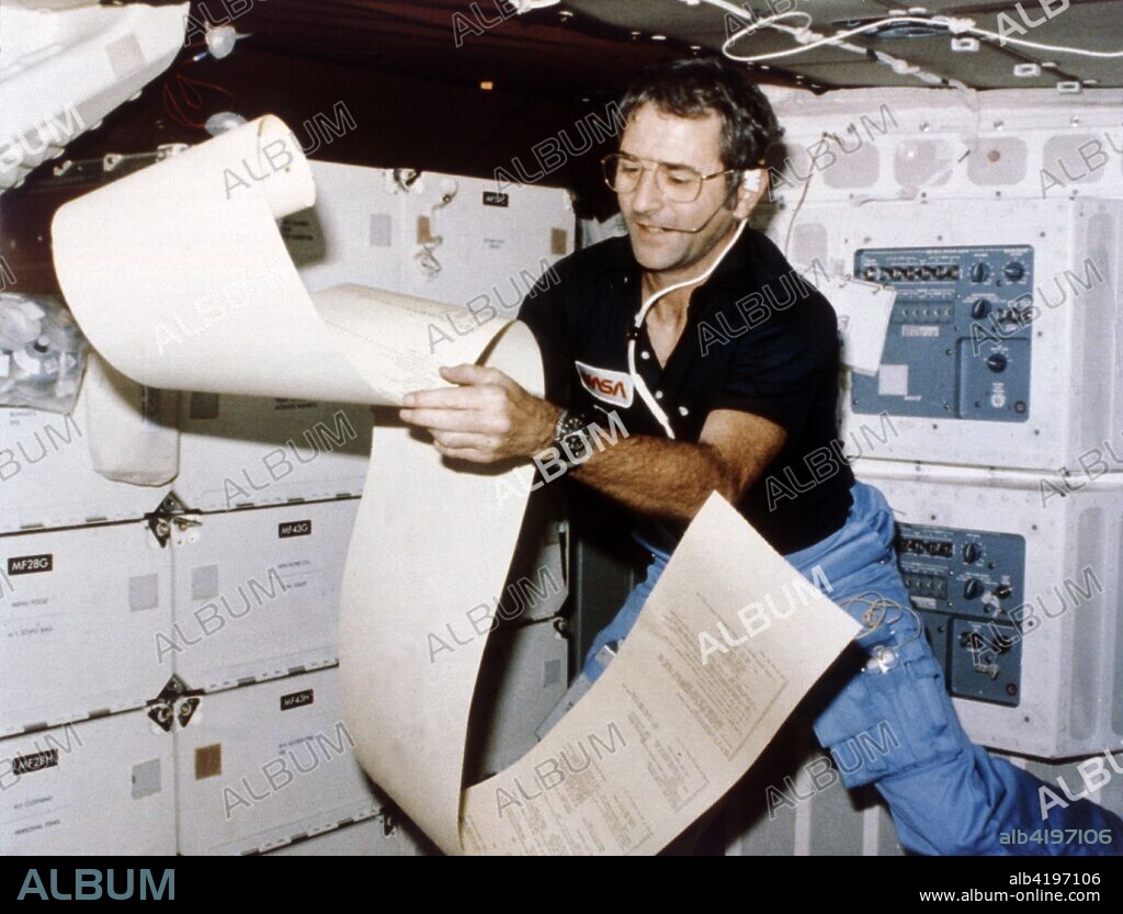 Astronaut Richard Truly, second Space Shuttle flight, November 1981. US fighter pilot and astronaut Joe Engle (born 1937) looks at data in zero gravity on the second flight of the Space Shuttle, STS-2. He was the first man to be launched into space on his birthday.