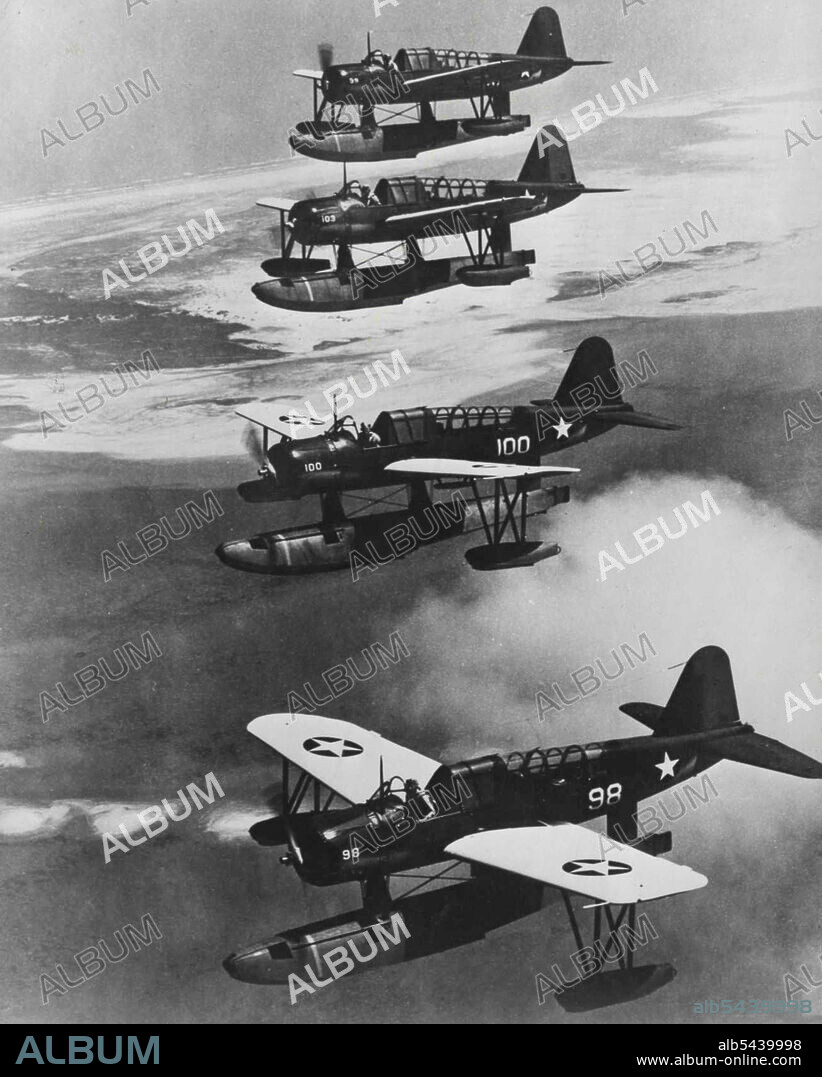 Navy Scouts In Formation -- Four U.S. Navy Observation Scout seaplanes present a striking picture as they wing their way in vertical echelon formation above the clouds. November 16, 1942. (Photo by U.S. Office of War Information Picture).