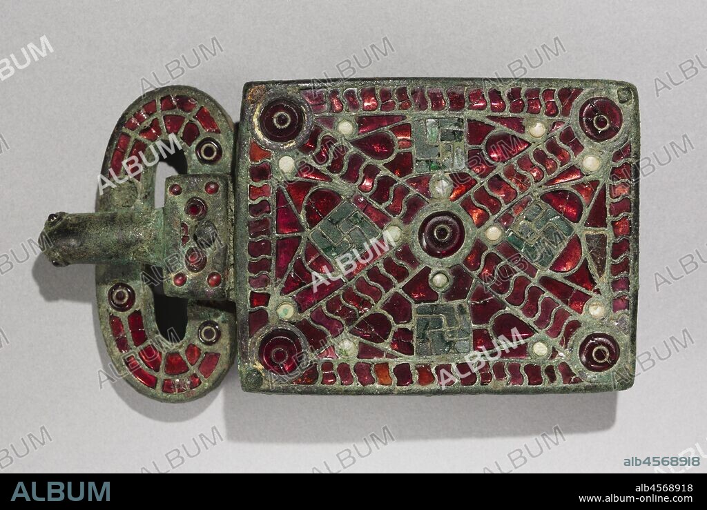 Belt Buckle, c. 525-560. The art of the European Migration Period (3rd-7th centuries AD) is almost exclusively one of personal adornment-a portable art that followed men and women to their graves. Belt buckles with large rectangular attachment plates have been discovered in cemeteries across the Iberian Peninsula-now occupied by Spain and Portugal-from the period of Visigothic occupation (about AD 412-711). Their decoration varies. Finer examples, like this one, are distinguished by brilliantly inlaid semi-precious stones and coloured glass. Garnets were especially prized in Visigothic society for use in cloisonné jewelry. The technique involved the fitting of carefully cut pieces of polished garnet into an intricate grid of compartments, or cloisons. This buckle is so densely inlaid with garnets that it presents a virtual "carpet" of red to the eye. These large Visigothic buckles are strikingly uniform in shape yet endlessly varied in surface design, perhaps a sign that they expressed the personal identities of their original owners. Grave excavations have shown that belt buckles of this type were made for women.