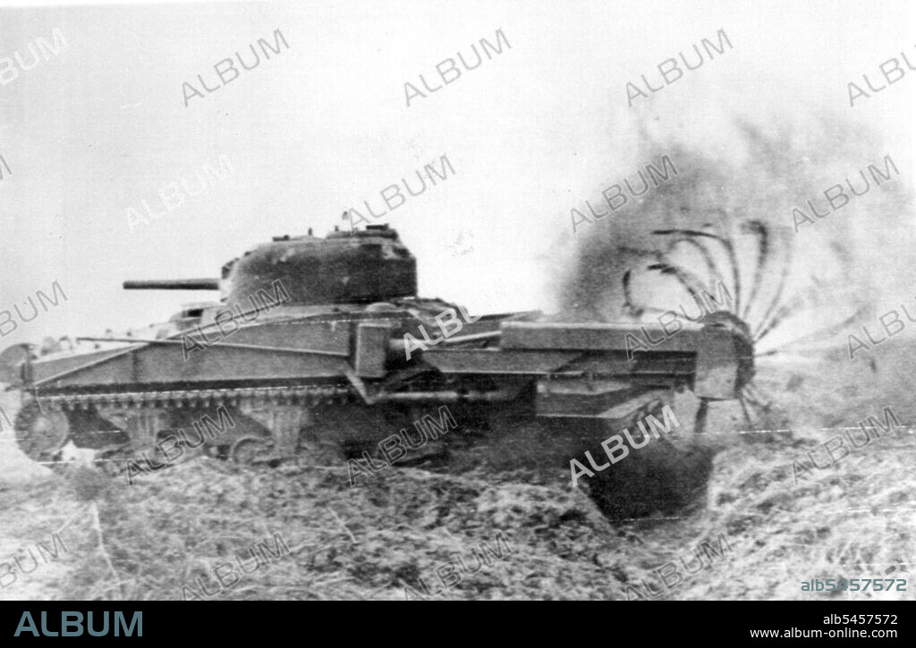 "Scorpion" Clears Mine Field In France -- This British flail tank, called a "Scorpion," beats the ground with chains to clear a path through a German mine field in Normandy. Lengths of chain are attached to a rotating cylinder mounted on a boom in front of the tank to lash the ground, exploding anti-personnel mines. June 29, 1944. (Photo by Associated Press Radiophoto).