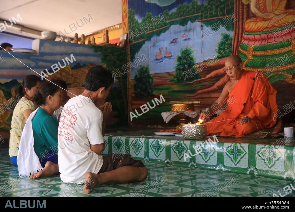 Ceremony. White thread. Sai Sin. Wat Simuong. Wat Si Muang. Vientiane, Laos.
