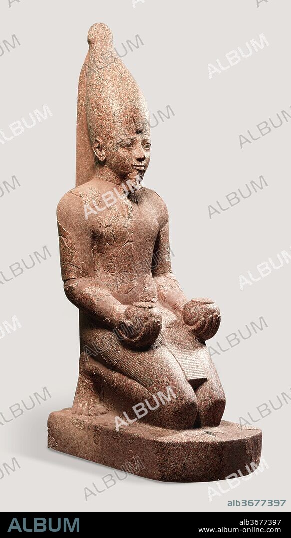 Large Kneeling Statue of Hatshepsut. Dimensions: H. 295.9 cm (116 1/2 in); w. of base 81.3 cm (32 in); d. of base 145.4 cm (57 1/4 in)
shipping weight in 2006, 3175.2 kg. (7000 lbs). Dynasty: Dynasty 18. Reign: Joint reign of Hatshepsut and Thutmose III. Date: ca. 1479-1458 B.C..
In her terraced temple at Deir el-Bahri, there were at least ten over life-sized kneeling statues of Hatshepsut. She is shown as a male king wearing a kilt, a false beard, and either the white crown of Upper Egypt (as in this statue), or the <i>nemes</i>-headcloth (see 29.3.1 and 30.3.2). In her hands she holds round offering vessels, called <i>nu</i>-pots, and the inscription on the base of each statue identifies the offering she makes to the god Amun. These huge statues flanked the processional way along which Amun's image was carried toward the temple's main sanctuary during a yearly festival. The statues were probably positioned on the temple's second terrace. 
This statue represents Hatshepsut wearing the white crown of Upper Egypt (the south), so it may have been placed on the southern side of the processional way. On the base, Hatshepsut is said to be offering fresh plants to Amun. On the back pillar, she is identified by her Horus name, <i>Wosretkau</i>, which is written in a rectangular device called a <i>serekh</i>. One also finds fragments of her throne name, <i>Maatkare</i>, and her personal name, Hatshepsut, both of which are written inside oval cartouches.
In 1930, the Museum's Egyptian Expedition found the body fragments of this statue buried in an area called the "Hatshepsut Hole." Some eighty years earlier, the head had been found and taken to Berlin by Egyptologist Richard Lepsius. The pieces of the statue were reunited in an exchange organized by Herbert Winlock, director of the Museum's excavations at Thebes. This and other exchanges were made possible by the generosity of the Egyptian Antiquities Service, which ceded many fragmentary statues to the Metropolitan Museum in the division of finds.