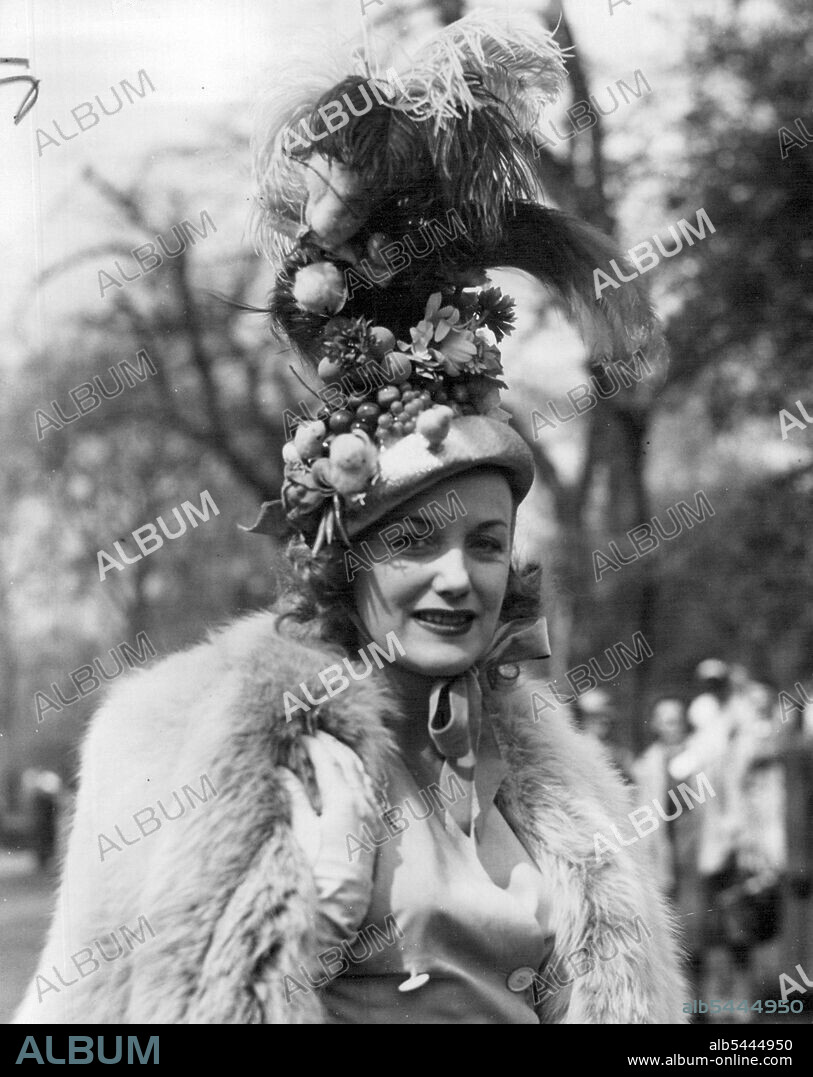 Easter Sundae - With feathers, flowers, fruit and even Easter chicks, this hat worn by radio and stage singer Judy Shirley has practically everything. Miss Shirley is seen at the Easter Parade, the first for 10 years, in Rotten Row, Hyde Park, London today (Sunday), when the latest products of Britain's fashion designers who are celebrating the end of clothes rationing, were on view to thousands of sightseers. April 17, 1949. (Photo by Reuterphoto).